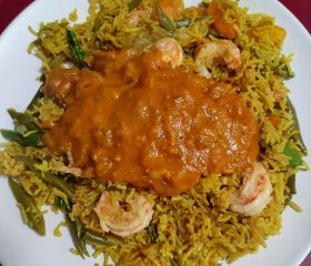 Prawn pilau with tomato and coconut sauce